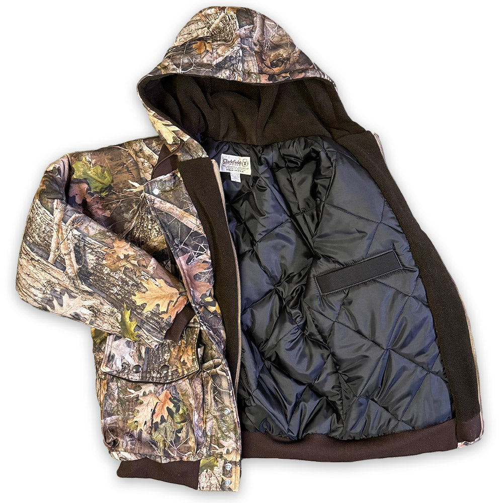 Camouflage jacket with a quilted black lining on a white background