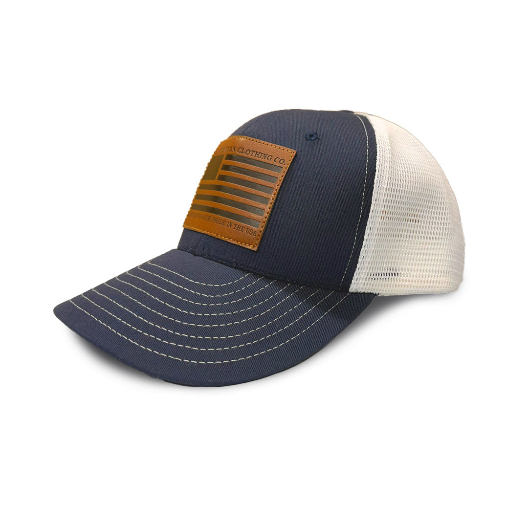 Navy blue and beige cap with leather patch on a white background